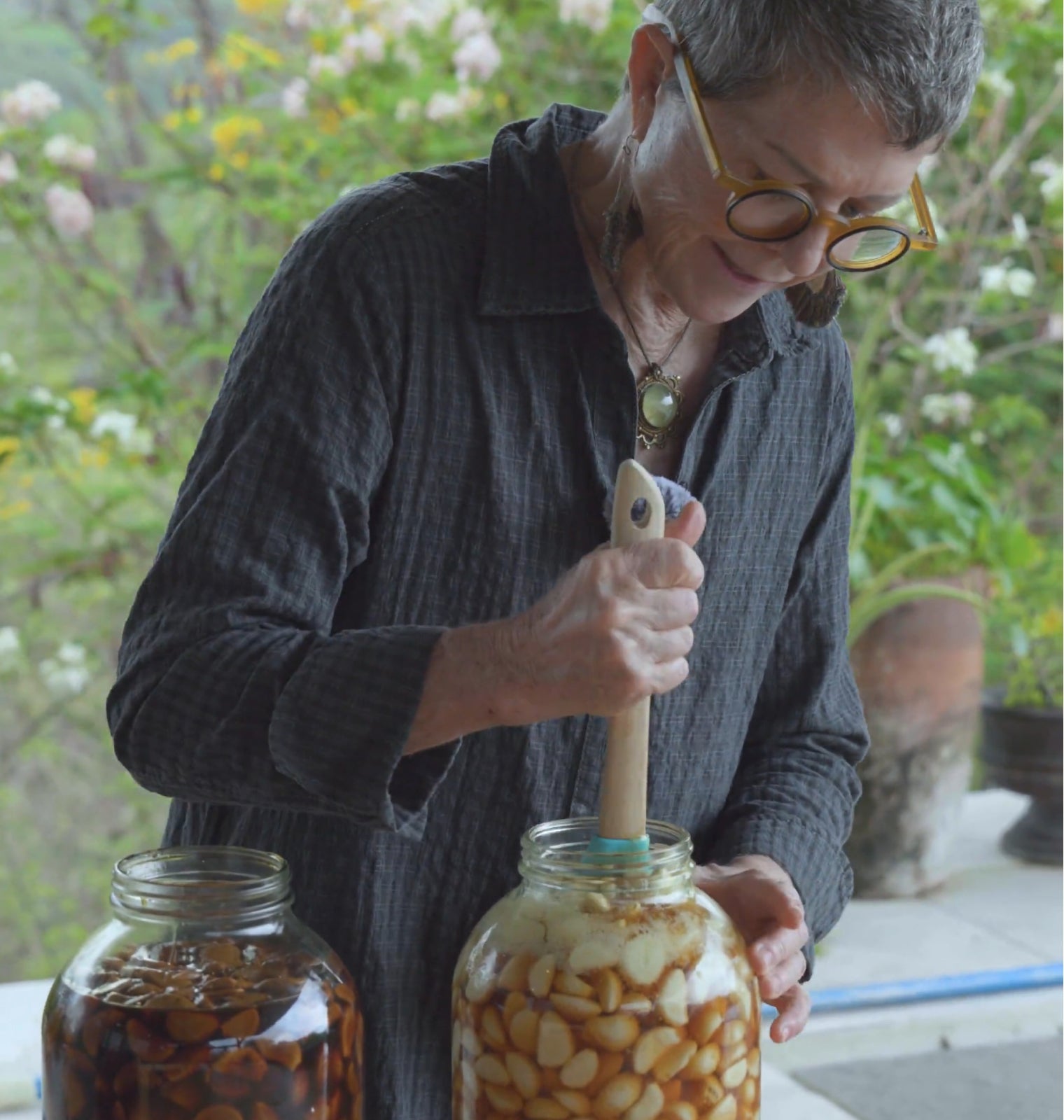 Kathryn preparing the garlic and honey ferment at the farm
